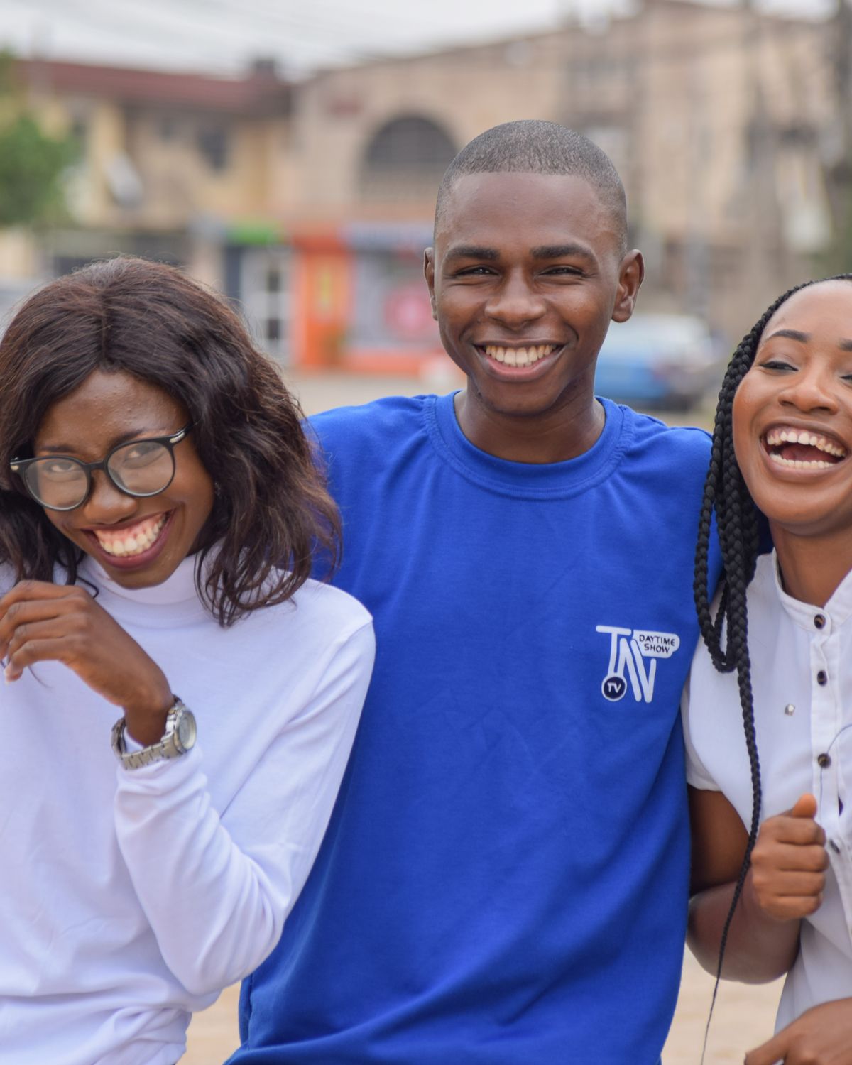 Three young adults laughing together